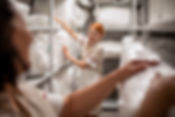 Close up of hotel maids picking up clean bedding and towels