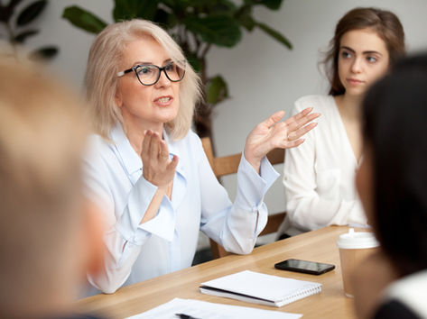 Woman speaking confidently in a business meeting.