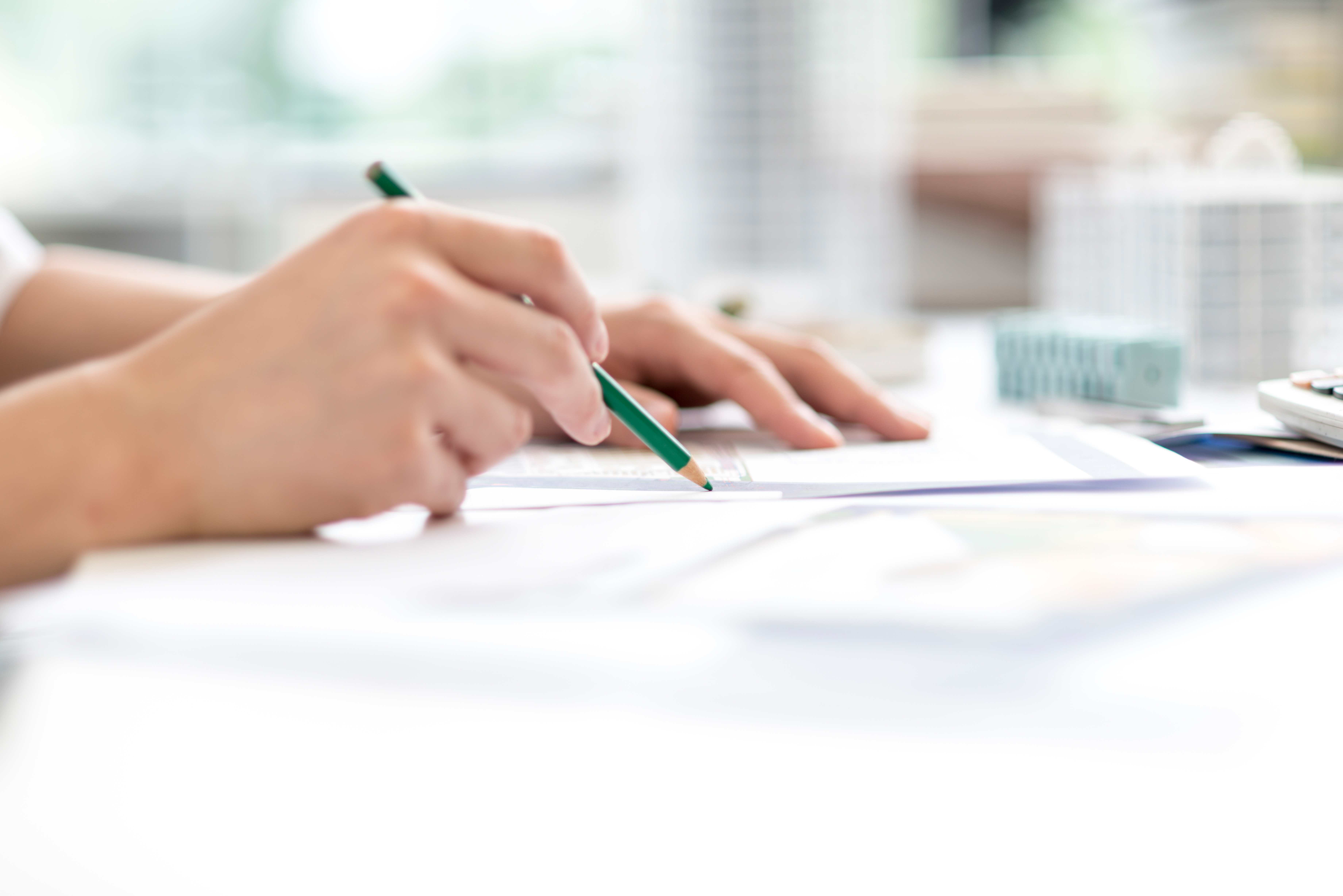 Grayston Alan Durtnell LLP — Close-up of an architect working on a blueprint in the office