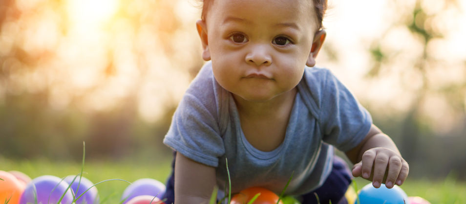 young baby crawling in grass