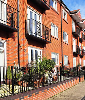 Modern red brick apartment development showcasing LivFinance’s expertise in property development loans and bridging finance for new residential projects.