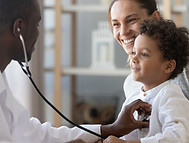 Doctor examining young boy