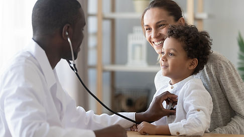 Doctor examining young boy