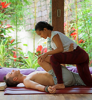 A woman giving a man a massage