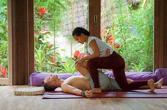 A woman giving a man a massage