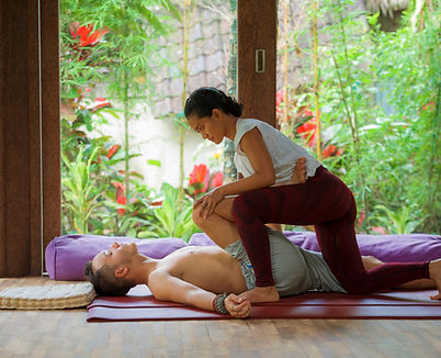 A woman giving a man a massage