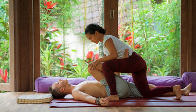 A woman giving a man a massage