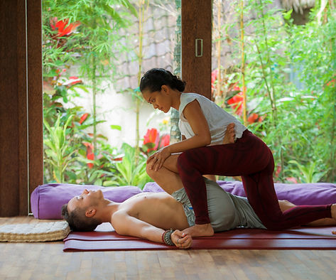 A woman giving a man a massage