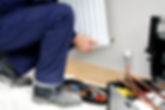 close-up image of a person's hand while fixing radiator