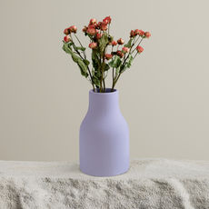minimalist flowers in a lavendar vase on a table