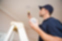 Man in navy uniform installs fire device on ceiling