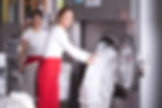 Two workers in laundry service,get washed sheets out of washing machine