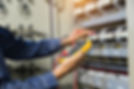 A technician is using a modern multimeter to test the Voltage