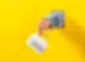White mug against yellow background