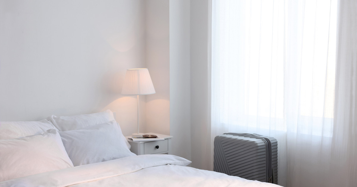 A calm, tidy bedroom with comfortable bedding, dim lighting and a peaceful atmosphere that supports restful sleep.