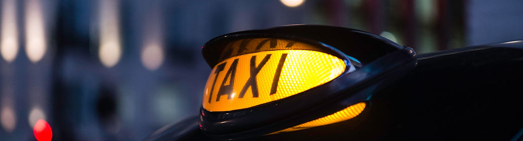 Close up image of the lit taxi sign on a London cab in Piccadilly Circus
