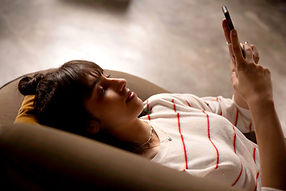 A person in Austin using their phone to schedule an appointment with a licensed professional counselor.