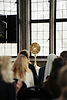 People kneeling in front of a monstrance in front of a bay of windows
