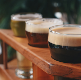 A flight of craft beer featuring a variety of styles and colors, served at a Southwest Minnesota brewery for a tasting experience.