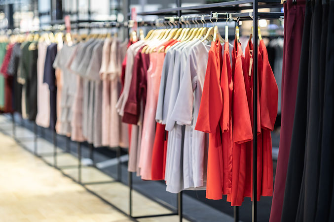 Clothes displaying on racks inside of a store