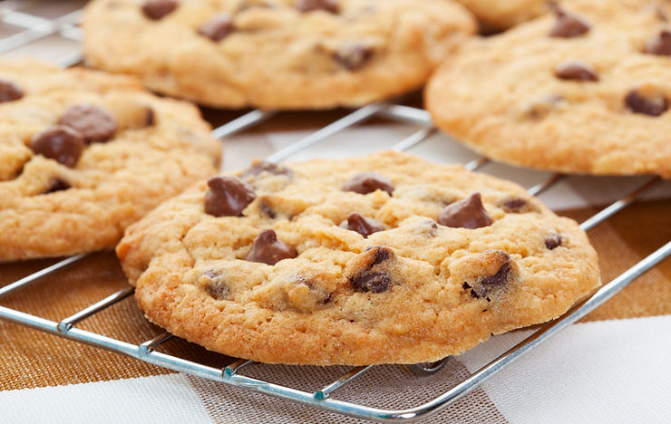 Freshly baked chocolate chip cookies cooling on wire rack – classic staff treat for workplace catering.