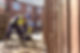 Apprentice builders laying paving stones on building site