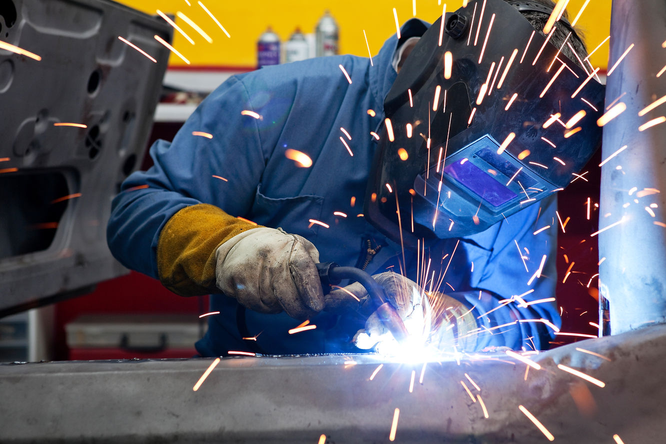 A mechanic performing welding repairs