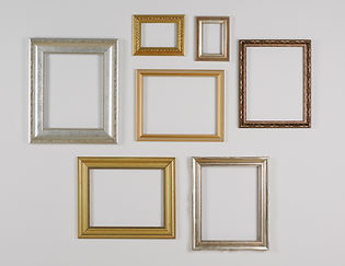 empty picture frames mounted on a wall