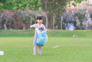 Kid Picking Up Trash In Park