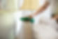 a person using green cloth for cleaning wooden surface