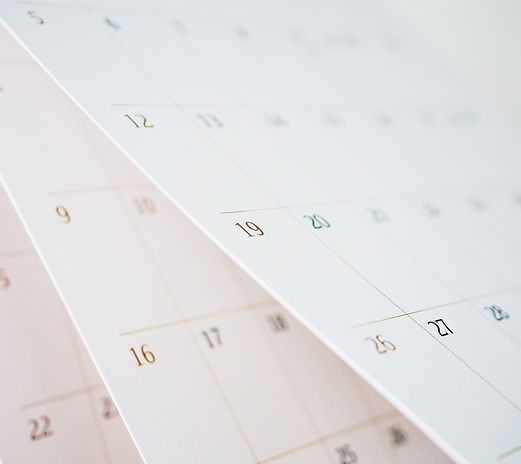A close-up of calendar pages with numbered dates, symbolizing automated photo date suggestions.