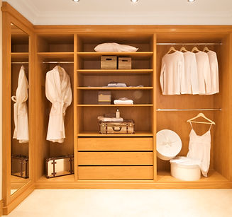 Open walk-in wardrobe with built-in warm lighting.