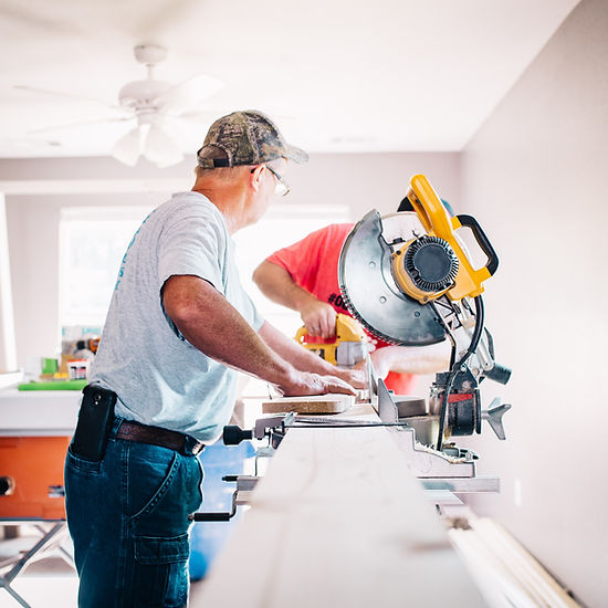 Handyman cutting material on miter saw