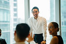 A man standing and smiling in front of the meeting room