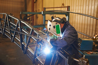 Welder working on metal frame