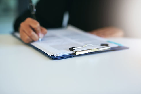 Closeup shot of a woman writing on a piece of paper