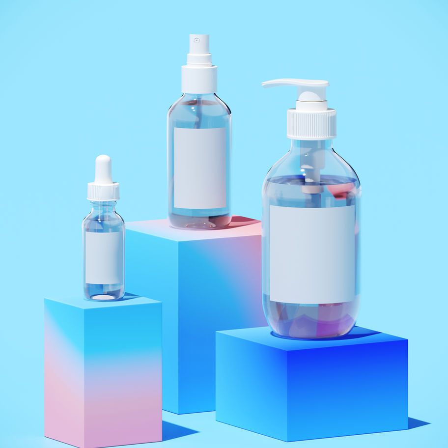 Three skincare bottles on colorful cubes