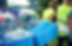 Individuals in safety vests recycle plastic bottles and cans