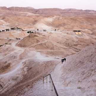 Hikers ascending the winding Snake Path trail on the eastern cliffs of Masada during a private guided tour of the Judean Desert.