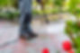 Senior man pressure washing yard