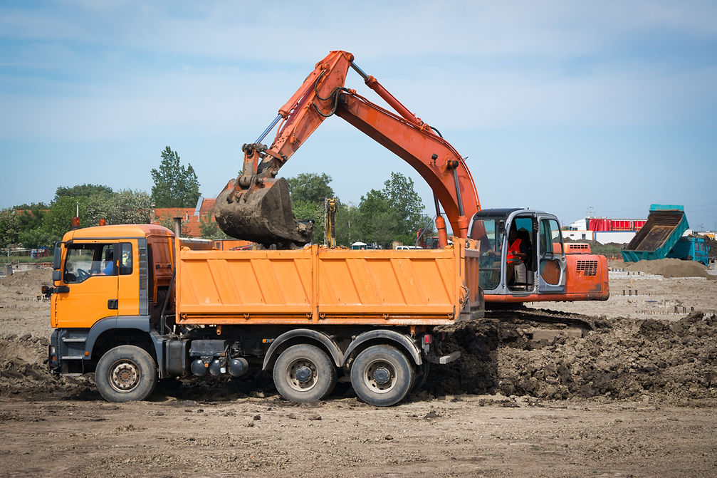 Excavator loading dirt into the truck