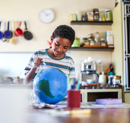 Child painting a globe