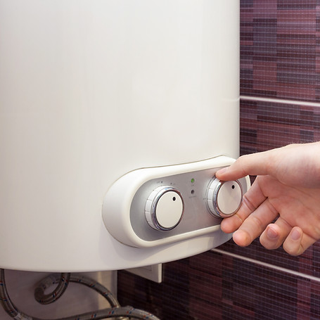 Close-up of man hands setting the temperature of water in Electric Boiler