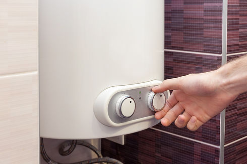 A technician is setting the timer on a boiler
