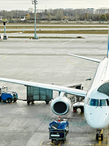 A commercial airplane docked at a terminal gate