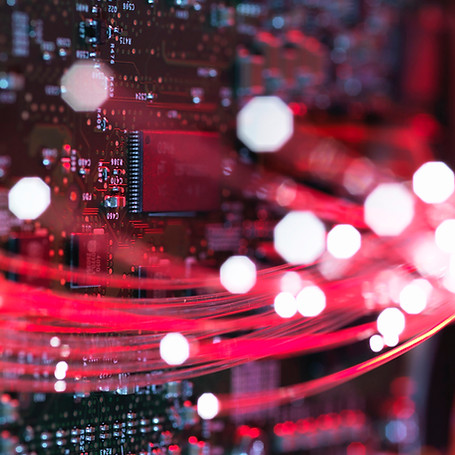 Fibre optics flowing through circuit boards from a laptop computer, close-up