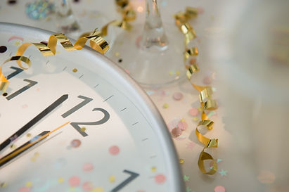 Clock with festive decorations around it to emphasize the importance of having someone run your wedding day timeline.