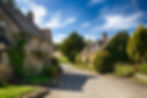 Stone houses and flower garden in Cotswolds village of Icomb