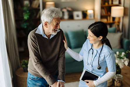 Nurse assisting elderly man