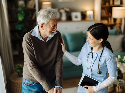 Nurse assisting elderly man